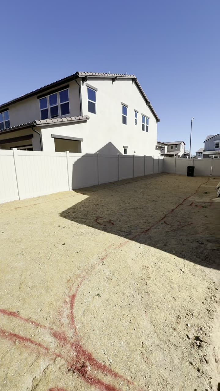 A bare new-construction backyard before landscape installation